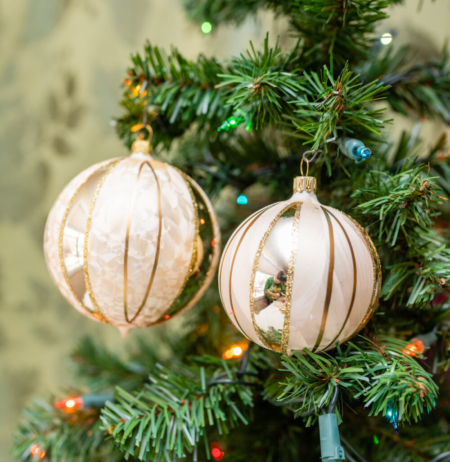 Two copper color balls hanging on the tree