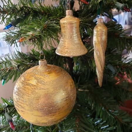 Antique Gold Balls, Cones and Bell hanging on the tree