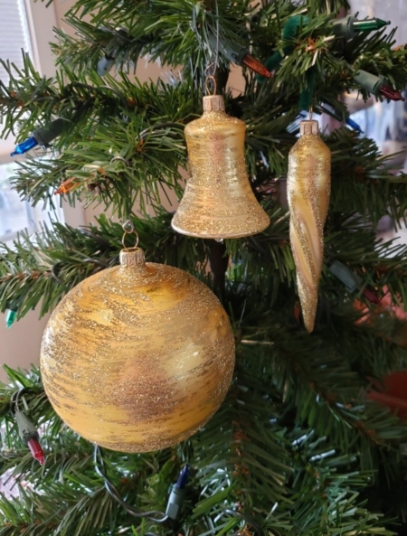 Antique Gold Balls, Cones and Bell hanging on the tree