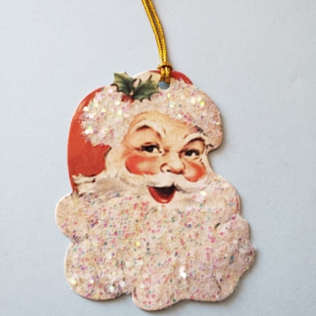 A glittery santa face with gold color hanging