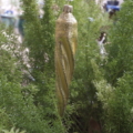 A closeup shot of a glittery gold cone hanging on a stand