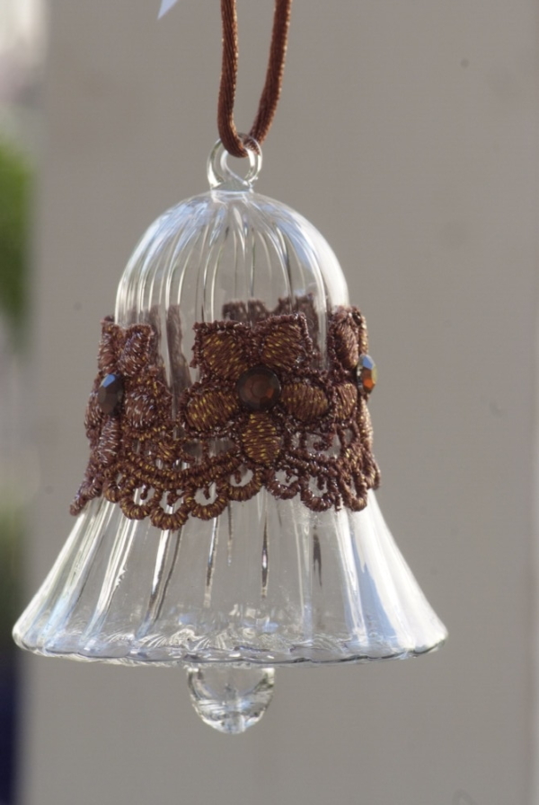 A long Egyptian Glass Crystal bell with a brown lace band