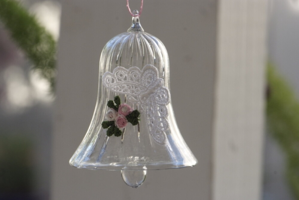 A crystal bell with white butterfly lace and flowers