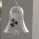 A crystal bell with white butterfly lace and flowers