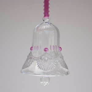 A crystal bell with white fancy lace and pink beads