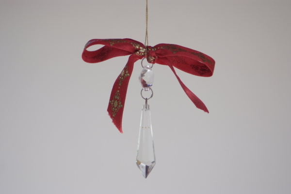 A long Carved diamond crystal with red ribbon