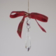 A long Carved diamond crystal with red ribbon