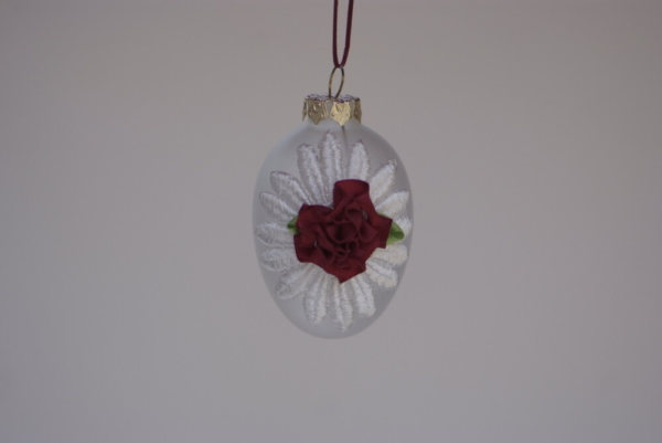 Egg shape hanging with white lace and a red rose