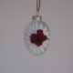 Egg shape hanging with white lace and a red rose